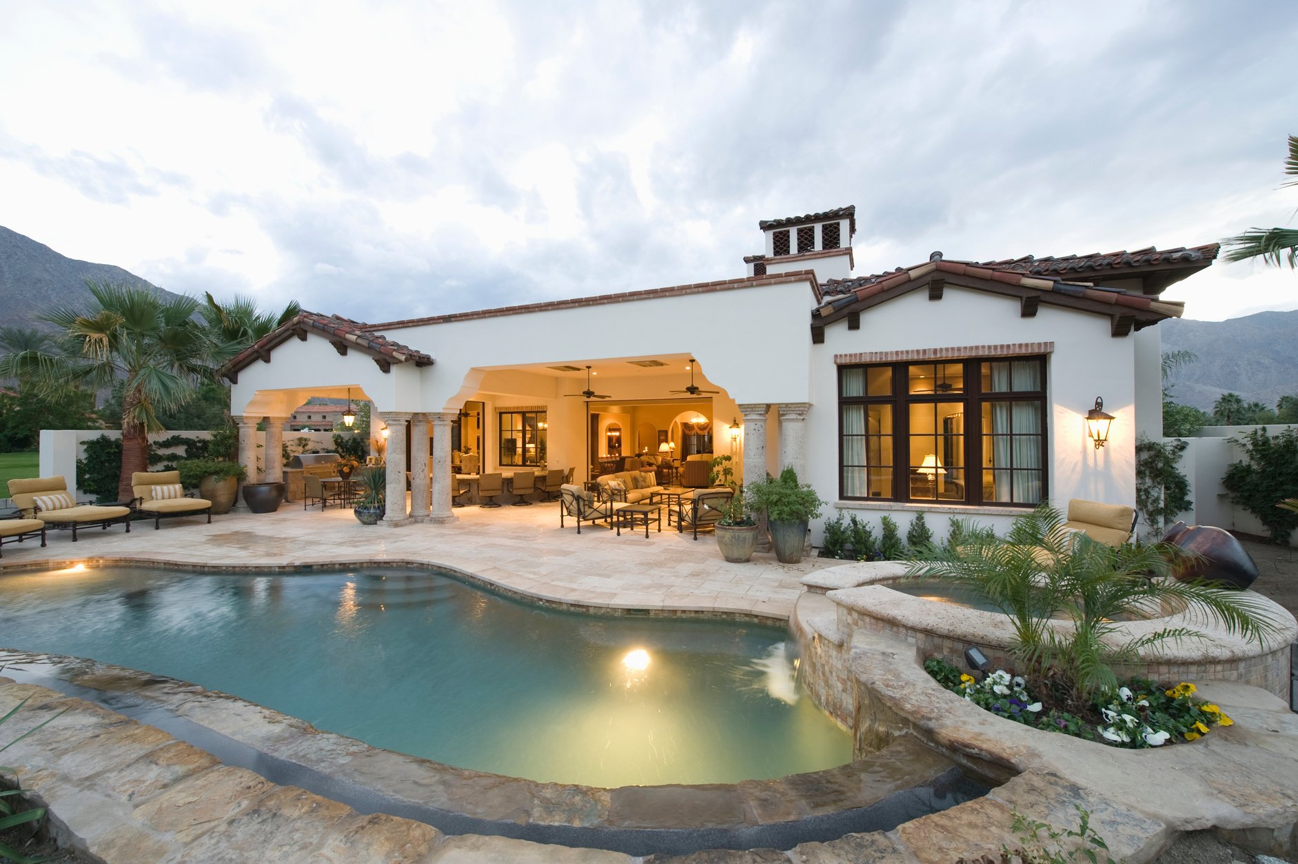 Poolside and lit interior of palm springs home